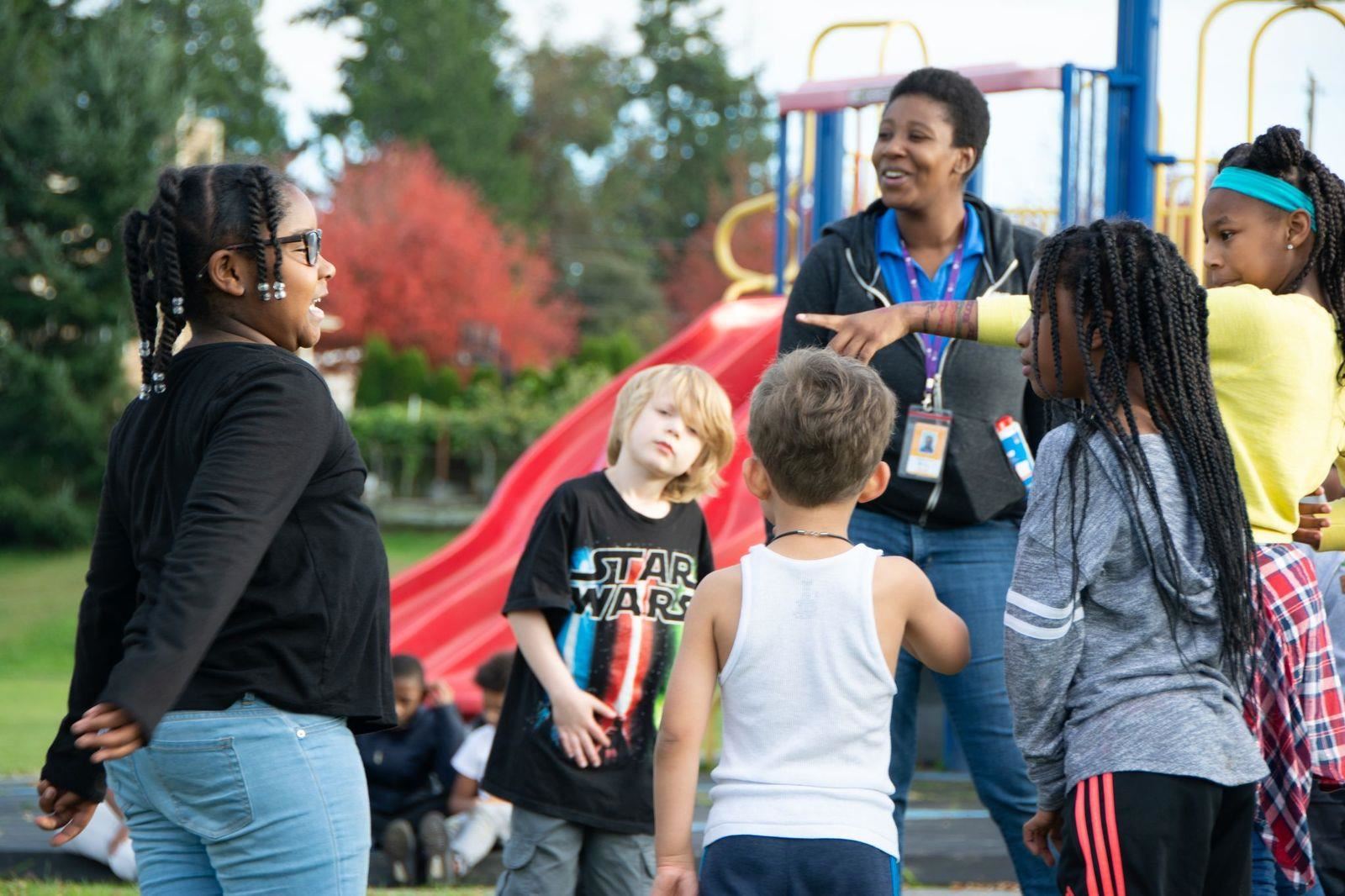 children on the playground with Right At School instructor