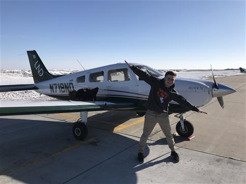 Tyler Dietrich in front of a plane 