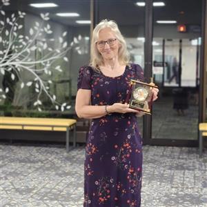 Peegy with her Ed of Year award May 2024