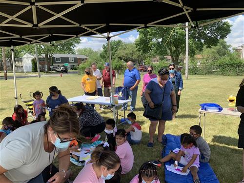 Children do activities under a tent 