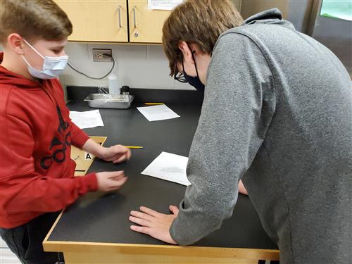 Two students working on a sketch together 