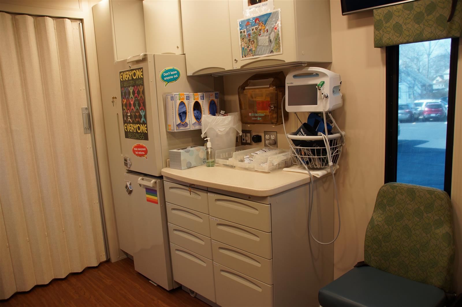  A health station with a vision chart and sink and medical signs 