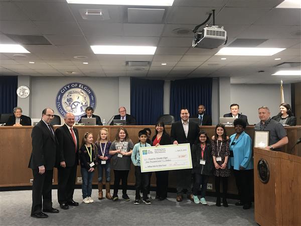 Students from Hilltop Elementary present a check to Food for Greater Elgin 