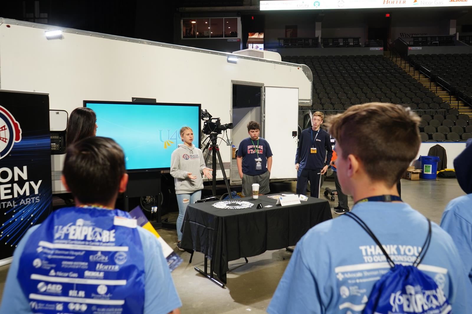 Students at an exhibit table at Explore 2022 