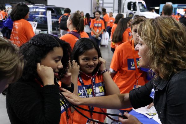  Students put on stethoscopes at the Explore event 