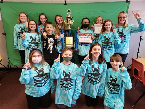  Fox Meadow students pose with a trophy from their Battle of the Books win 