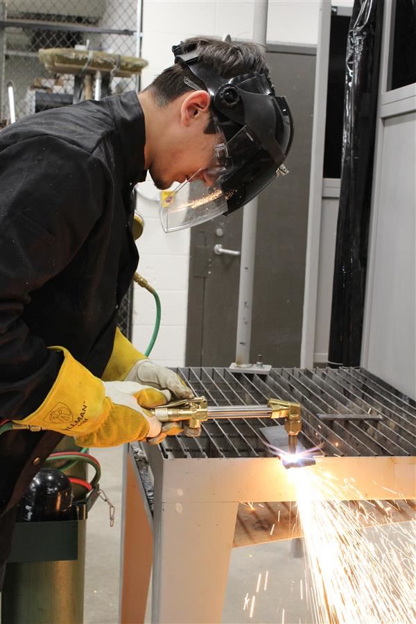 A student welds in the new Elgin High School welding lab 