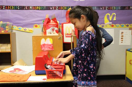 A student in Fox Meadow Elementary in the pretend McDonald's restaurant 