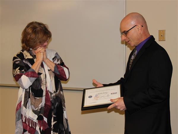 Melanie Meidel receives an award from the Department of Defense 