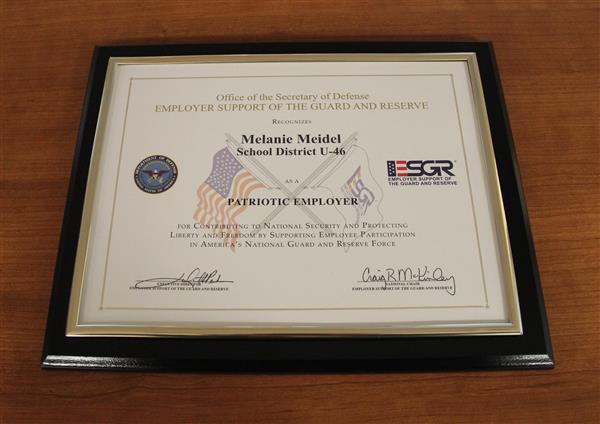 Melanie Meidel receives an award from the Department of Defense 