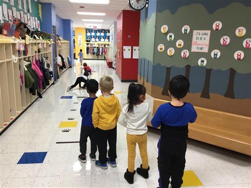 Children lined up in hallway for sensory path 