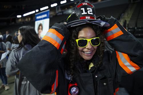 U-46 middle student tries on firefighter gear at Explore 2019 